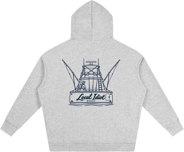 Back: navy sportfishing boat from the stern, the transom reading Local Idiot, BONAC