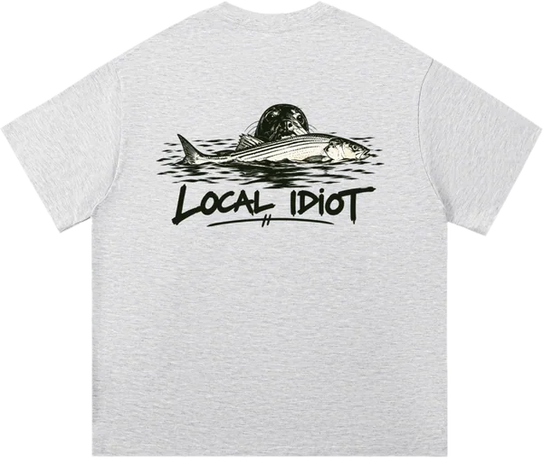 Back: striped bass at the surface with a seal right behind it, LOCAL IDIOT in brush lettering below