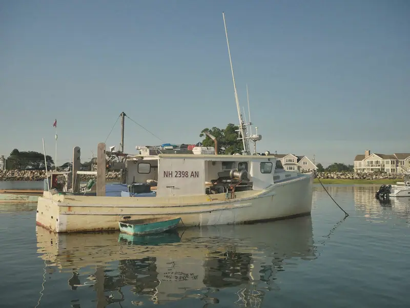 A workboat moored in a small harbor